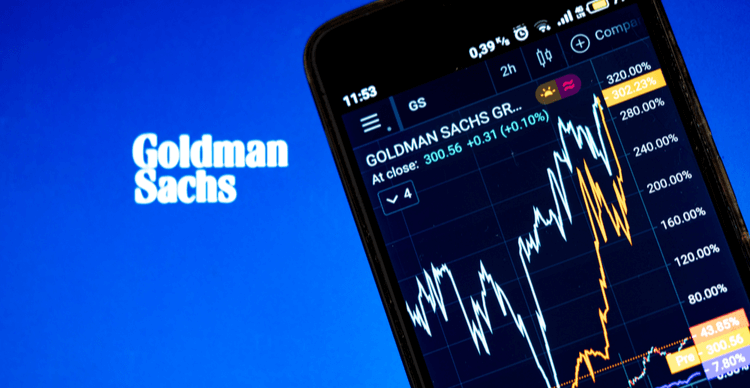 The Goldman Sachs logo against a stock chart