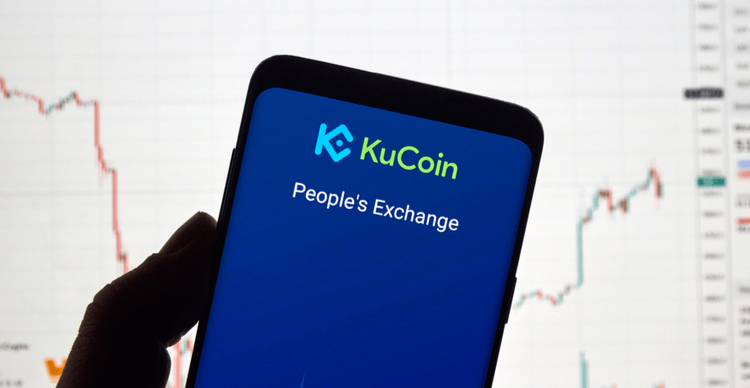 Image of the KuCoin app in front of a screen displaying a price chart